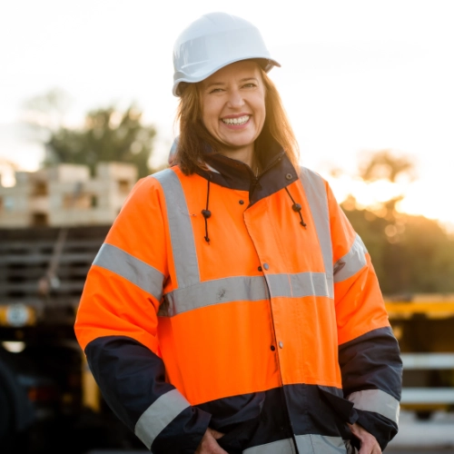 Tier 1 infrastructure contractor wearing high-visibility clothing and a hard hat on site